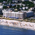 Old aerial view of the Boardwalk Plaza Hotel with people at the beach