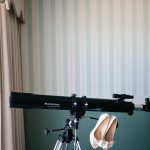 Telescope with wedding shoes hanging