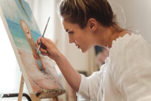 A woman painting the Rehoboth Beach art scene.