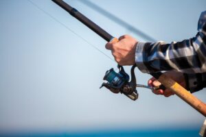 Fishing on the Delaware Coast Near Rehoboth Beach: A close of a man's hands while fishing
