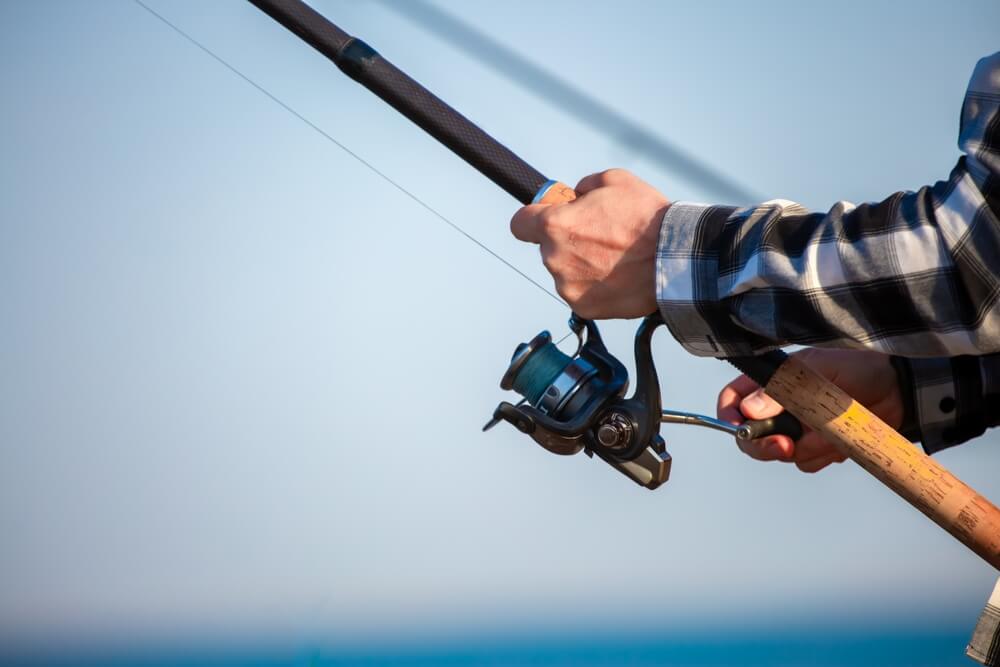 Fishing on the Delaware Coast Near Rehoboth Beach: A close of a man's hands while fishing
